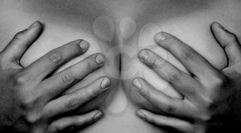 Upper part of female body, hands covering breasts, grey