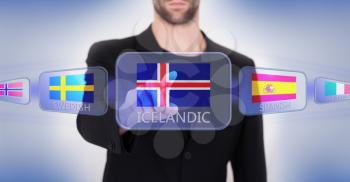 Hand pushing on a touch screen interface, choosing language or country, Iceland