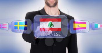 Hand pushing on a touch screen interface, choosing language or country, Lebanon
