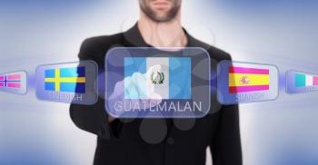 Hand pushing on a touch screen interface, choosing language or country, Guatemala