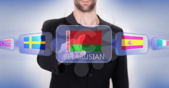 Hand pushing on a touch screen interface, choosing language or country, Belarus
