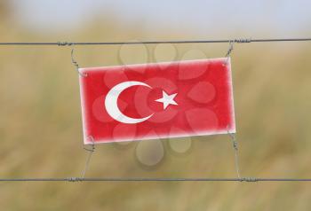 Border fence - Old plastic sign with a flag - Turkey