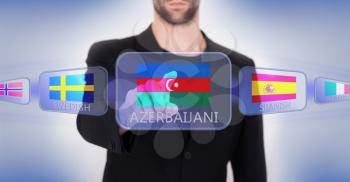 Hand pushing on a touch screen interface, choosing language or country, Azerbaijan