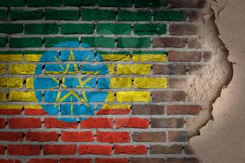 Dark brick wall texture with plaster - flag painted on wall - Ethiopia