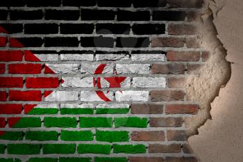 Dark brick wall texture with plaster - flag painted on wall - Western Sahara