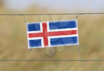 Border fence - Old plastic sign with a flag - Iceland