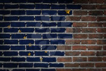 Very old dark red brick wall texture with flag - Alaska