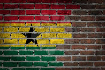 Very old dark red brick wall texture with flag - Ghana