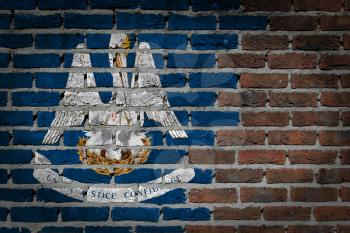 Very old dark red brick wall texture with flag - Louisiana