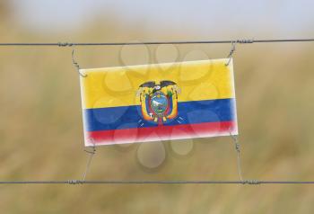 Border fence - Old plastic sign with a flag - Ecuador
