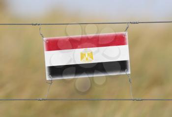 Border fence - Old plastic sign with a flag - Egypt