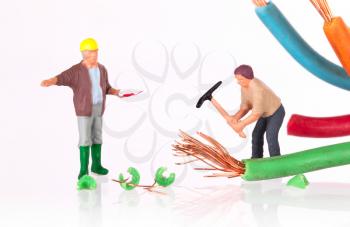 Miniature workers with pickaxe working on a broken cable