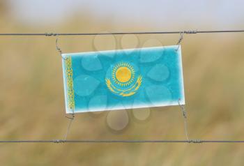 Border fence - Old plastic sign with a flag - Kazakhstan