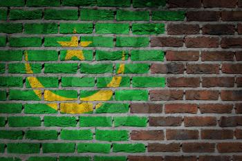 Very old dark red brick wall texture with flag - Mauritania