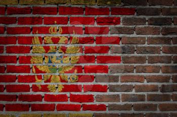 Very old dark red brick wall texture with flag - Montenegro