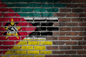 Very old dark red brick wall texture with flag - Mozambique