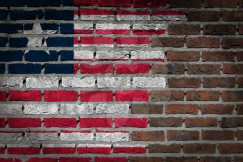 Very old dark red brick wall texture with flag - Liberia