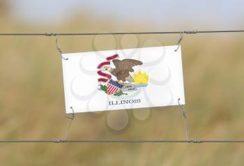 Border fence - Old plastic sign with a flag - Illinois