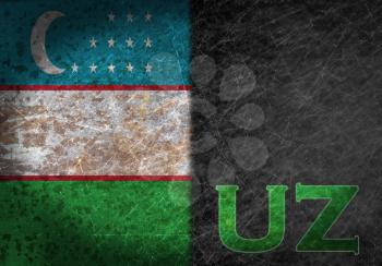Old rusty metal sign with a flag and country abbreviation - Uzbekistan