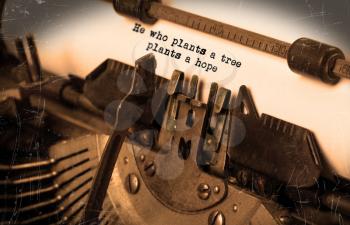 Close-up of an old typewriter with paper, selective focus, he who plants a tree plants a hope