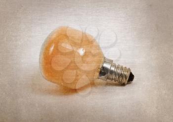 Old orange lightbulb isolated on a white background - Vintage look