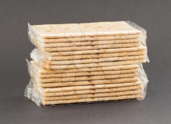 Crackers in plastic, isolated on a grey background
