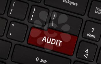 Audit text on red keyboard button - financial and business concept