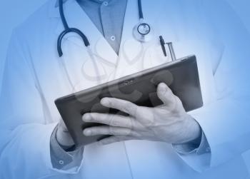 Doctor using a digital tablet, selective focus on tablet, medical blue