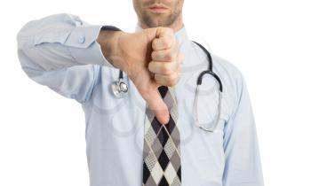Caucasian male doctor making a dislike gesture keeping thumb down