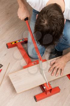 Red tool for cutting laminate on a laminate floor