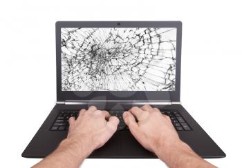 Man working on a laptop with a broken screen, white