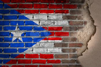 Dark brick wall texture with plaster - flag painted on wall - Puerto Rico