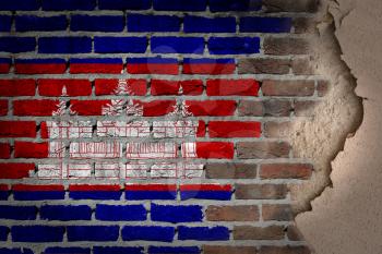 Dark brick wall texture with plaster - flag painted on wall - Cambodia