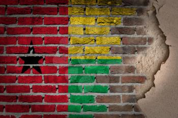 Dark brick wall texture with plaster - flag painted on wall - Guinea Bissau