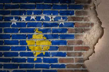 Dark brick wall texture with plaster - flag painted on wall - Kosovo