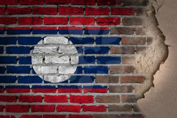 Dark brick wall texture with plaster - flag painted on wall - Laos