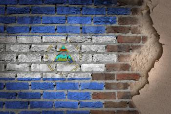 Dark brick wall texture with plaster - flag painted on wall - Nicaragua