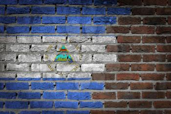 Very old dark red brick wall texture with flag - Nicaragua