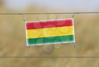 Border fence - Old plastic sign with a flag - Bolivia