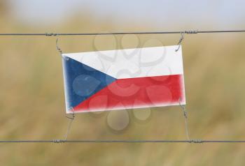 Border fence - Old plastic sign with a flag - Czech Republic
