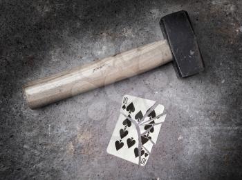 Hammer with a broken card, vintage look, ten of spades