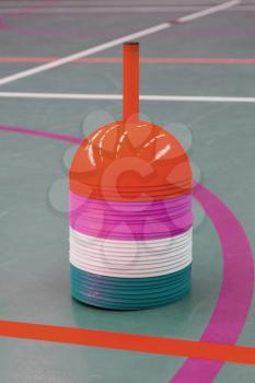 Interior of a gym at school, different colors of cones