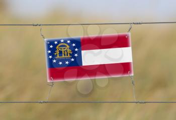 Border fence - Old plastic sign with a flag - Georgia