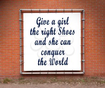 Large banner with inspirational quote on a brick wall - Give a girl the right shoes