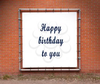 Large banner with inspirational quote on a brick wall - Happy birthday to you