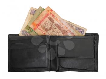 Gambian dalasi bank notes in a leather wallet, selective focus