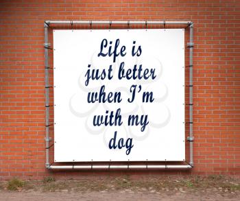 Large banner with inspirational quote on a brick wall - Life is better when I'm with my dog