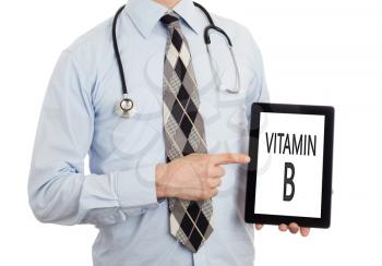 Doctor, isolated on white backgroun,  holding digital tablet - Vitamin B