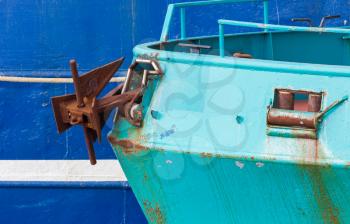 Nose of the green fishing ship, larger blue ship in the background