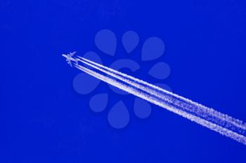 Large aircraft flying in sky, 4 stripes in the sky - Bright blue sky